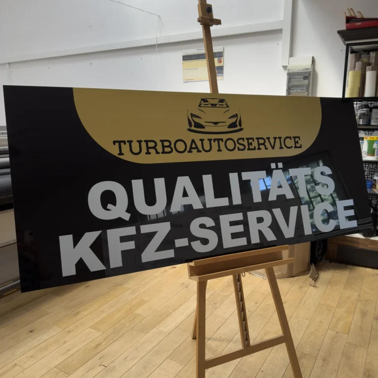 Szyld reklamowy UV na czarnym dibondzie z dużym nadrukiem literowym