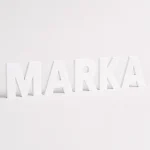Białe litery z PCV tworzące napis marki na jasnym tle